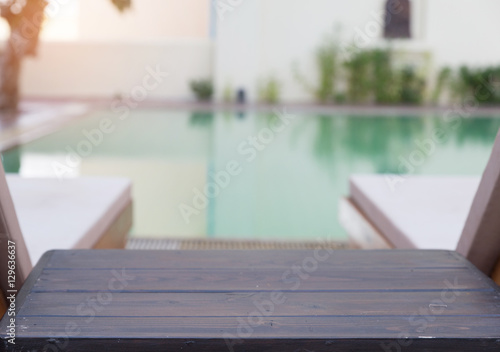 wood table and pool chair for resting and relaxing at swimming p