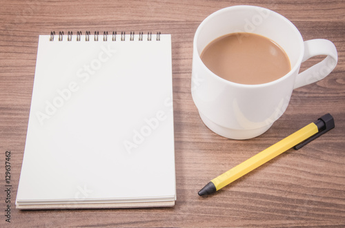 Blank notebook and hot coffee