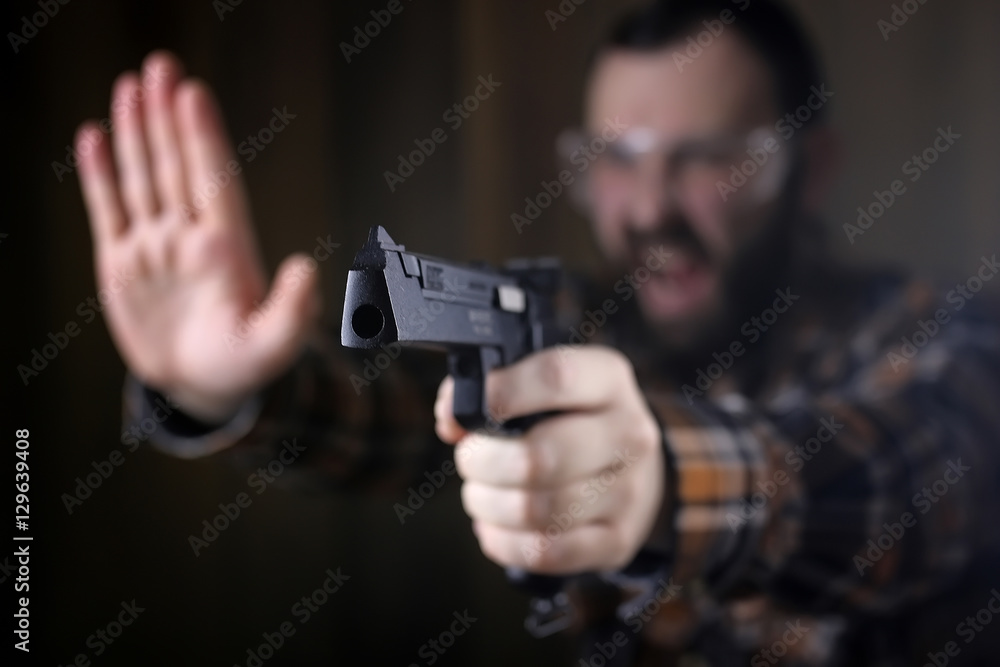 man with put on protective goggles and ear training in pistol sh man with put on protective goggles and ear training in pistol sh
