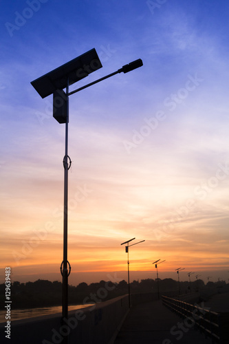 Twilight silhouette solar electric pole.