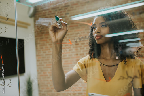 Woman writing at glass photo