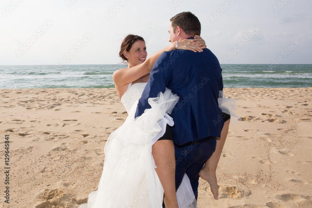 lover groom with bride on the summer beach in tropics lover groom with bride on the summer beach in tropics