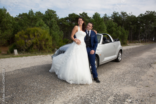 wedding couple sitting on the marriage convertible grey car © OceanProd