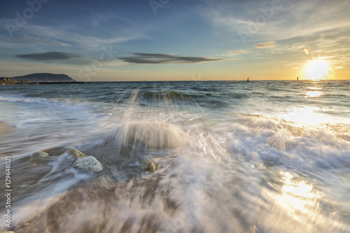 Waves crashing on the sandy beach framed by sunrise, Porto Recanati, Province of Macerata, Conero Riviera, Marche photo