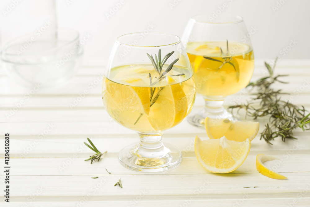 Lemonade with fresh lemon on white