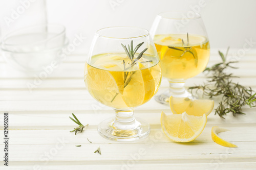 Lemonade with fresh lemon on white
