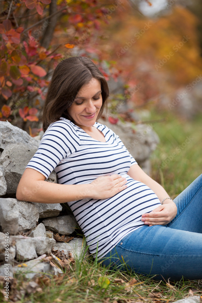 Beautiful pregnant caucasian woman in autumn Beautiful pregnant caucasian woman in autumn