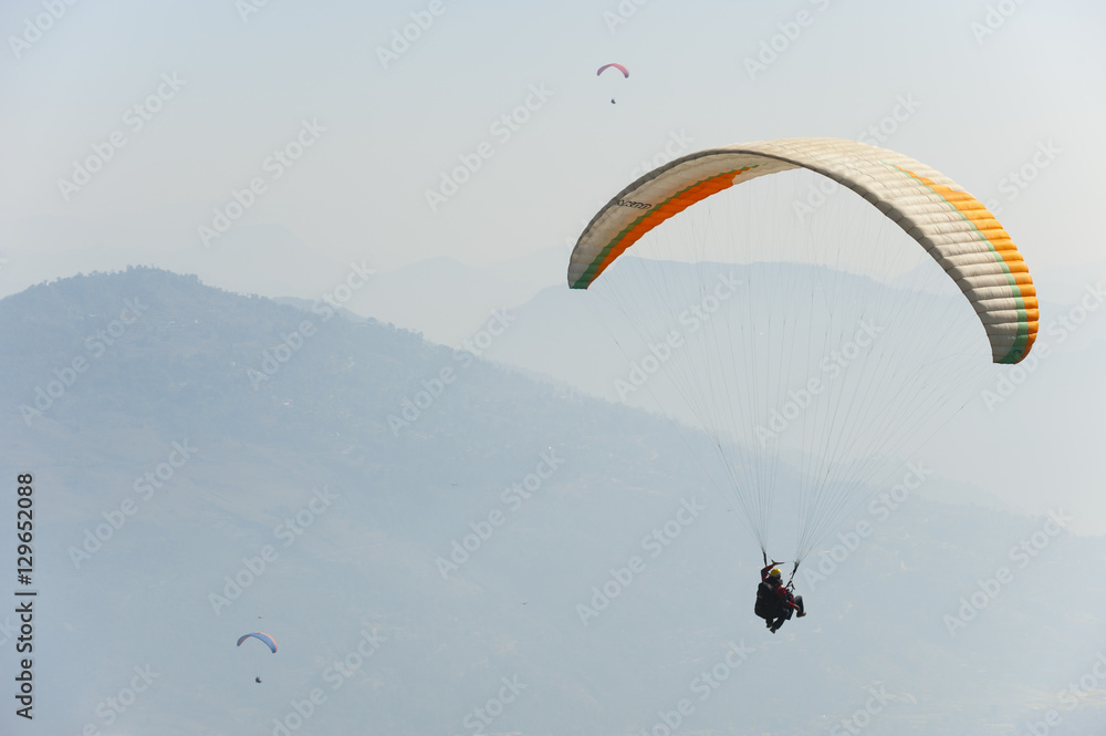 Paragliders flying above Pokhara, Nepal, Himalayas Paragliders flying above Pokhara, Nepal, Himalayas