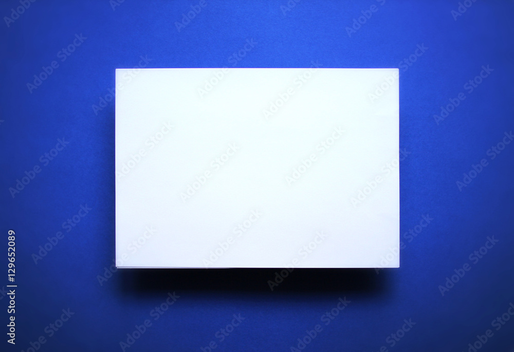 Empty white paper sheet blue background Empty white paper sheet blue background