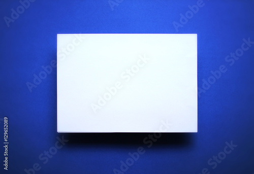 Empty white paper sheet blue background