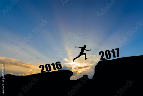 man jump between 2016 and 2017 years on sunset background.