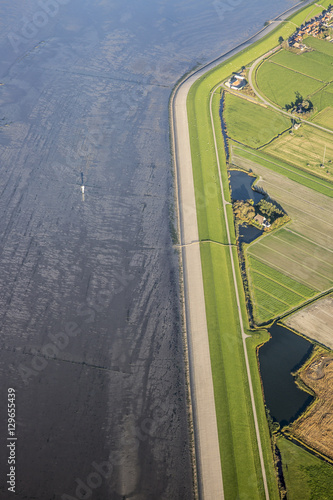 Quadro su tela Aerial coastal view of the shore of Ameland Frisian Island with green fields, di