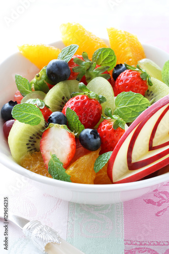                                      A bowl of healthy fresh fruit salad with carved from apple