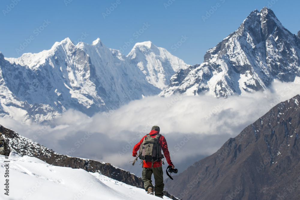 A photographer working in the Everest region of the Nepal Himalayas, Khumbu Region, Nepal A photographer working in the Everest region of the Nepal Himalayas, Khumbu Region, Nepal