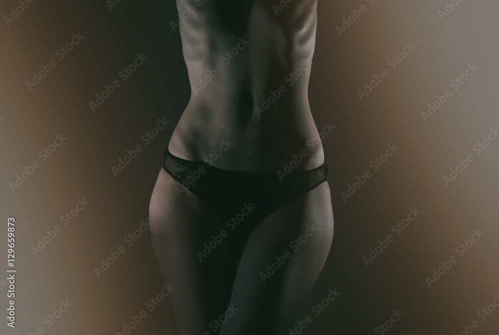 Front view of slim female body in black panties. - obrazy, fototapety, plakaty 