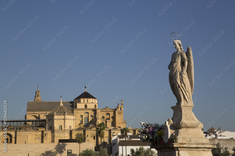 Statue of Raphael the Archangel with the Great Mosque (Mesquita) and Cathedral of Cordoba in the background, Cordoba, Andalucia, Spain Statue of Raphael the Archangel with the Great Mosque (Mesquita) and Cathedral of Cordoba in the background, Cordoba, Andalucia, Spain