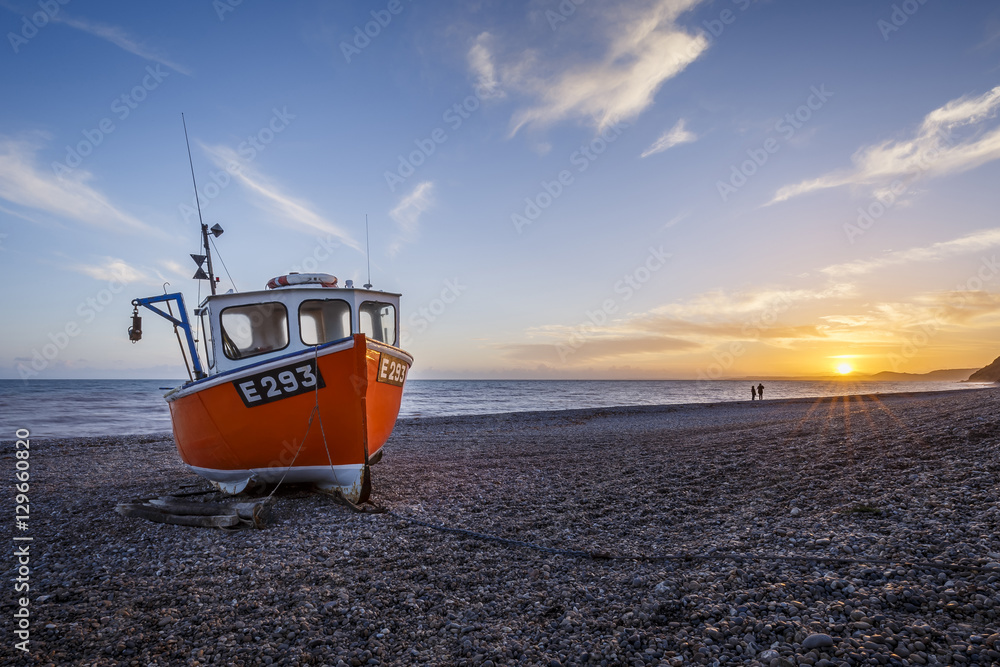 Fishing boat moored on Branscombe Beach at sunset, Seaton, East Devon Fishing boat moored on Branscombe Beach at sunset, Seaton, East Devon
