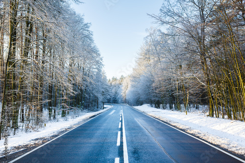 Road in a winter forest © castenoid
