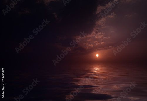 Dramatic sunset with clouds reflected in water.