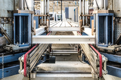 Manual worker assembling glass panels for PVC windows. Manufacturing jobs.Factory for aluminum and PVC windows and doors production. Tempered float glass panels