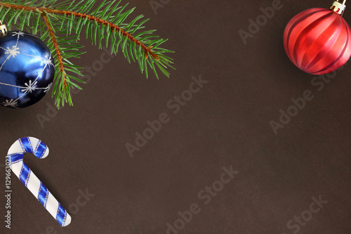 Dark background with Christmas fir branch, stick, blue and red wavy ball photo