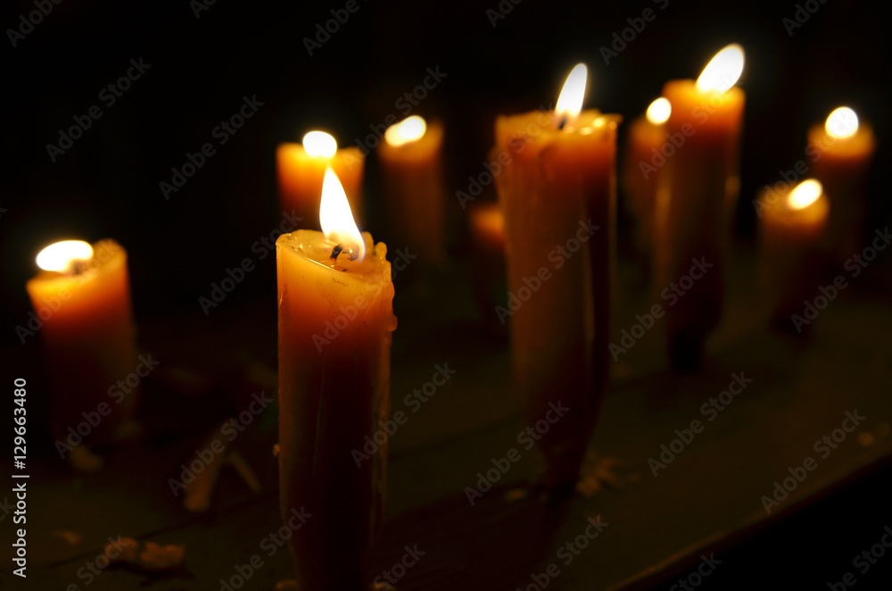 Antique candle burning in a dark room. Christmas Eve, divination, yuletide. Christmas backgrounds. holiday rituals, religion, spirituality, zen. space for text, close-up, copy space Antique candle burning in a dark room. Christmas Eve, divination, yuletide. Christmas backgrounds. holiday rituals, religion, spirituality, zen. space for text, close-up, copy space