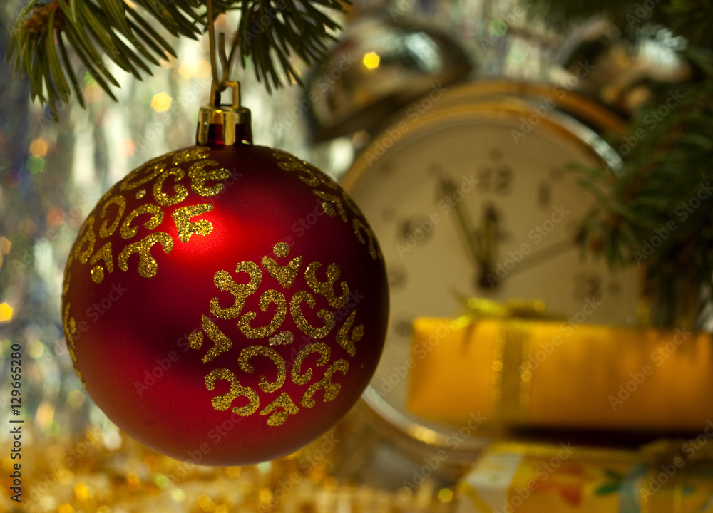 Red Christmas ball decorate on tree. Gift boxes. Midnight clock on bokeh background.