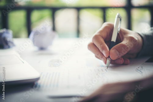 Business Woman Writing with pen in notepad, working woman concep