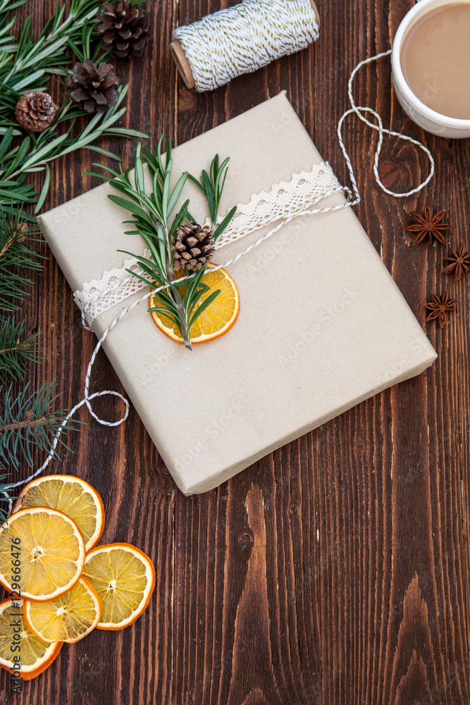 Gift in a craft package on the wooden table. Handmade gift prepa Gift in a craft package on the wooden table. Handmade gift prepa