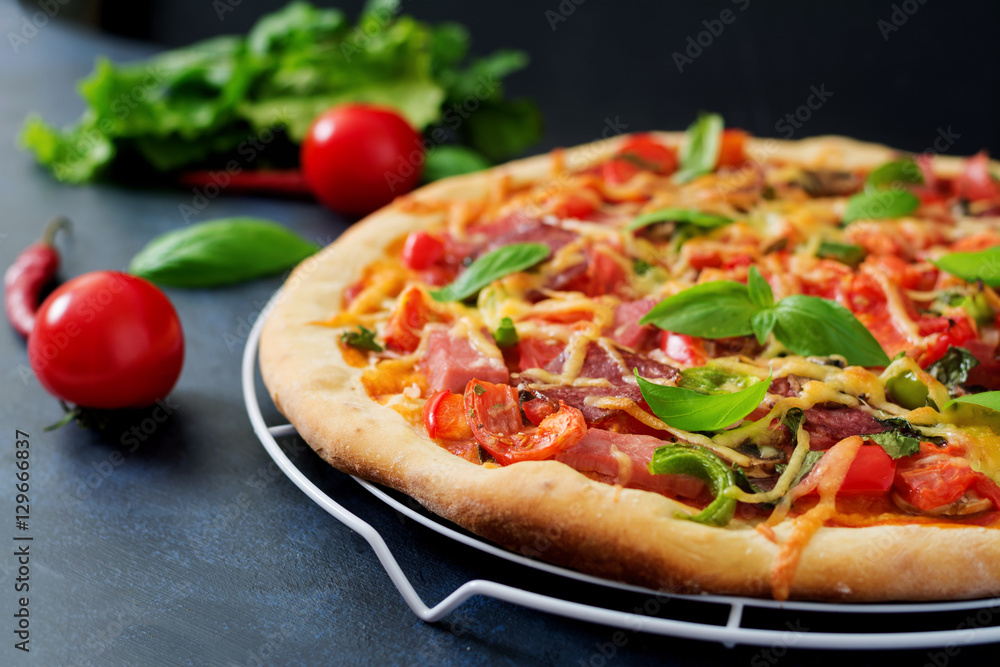 Pizza with salami, ham, tomato, cheese and mushrooms Pizza with salami, ham, tomato, cheese and mushrooms