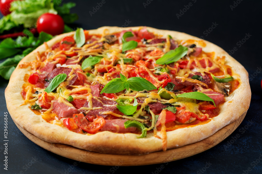 Pizza with salami, ham, tomato, cheese and mushrooms Pizza with salami, ham, tomato, cheese and mushrooms