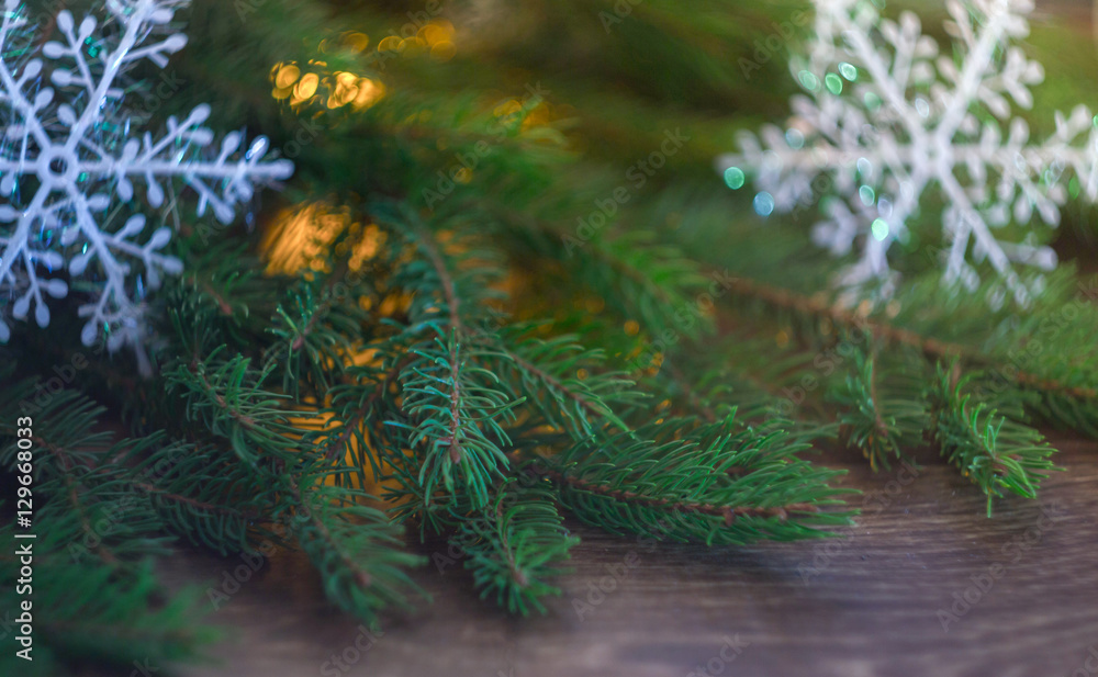 decorations on a Christmas tree branch on a wooden background