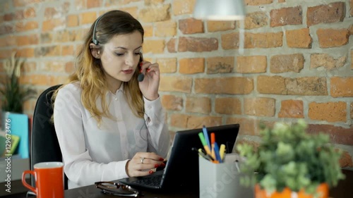 Call center agent looks very angry while talking with customer
 photo