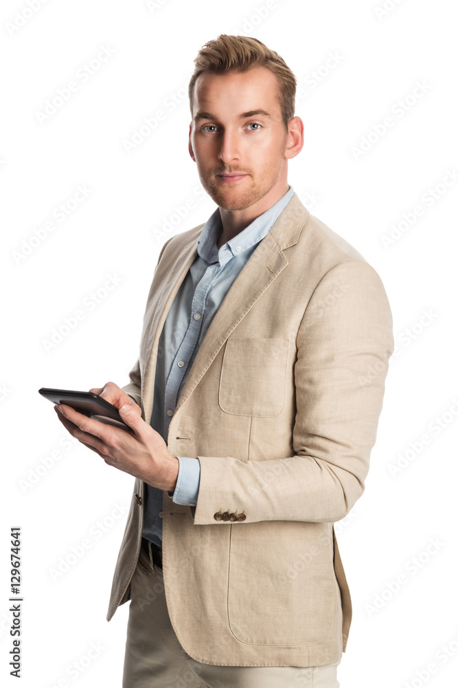 Mature man wearing a bright khaki blazer standing against a white background smiling holding a digital tablet. Mature man wearing a bright khaki blazer standing against a white background smiling holding a digital tablet.