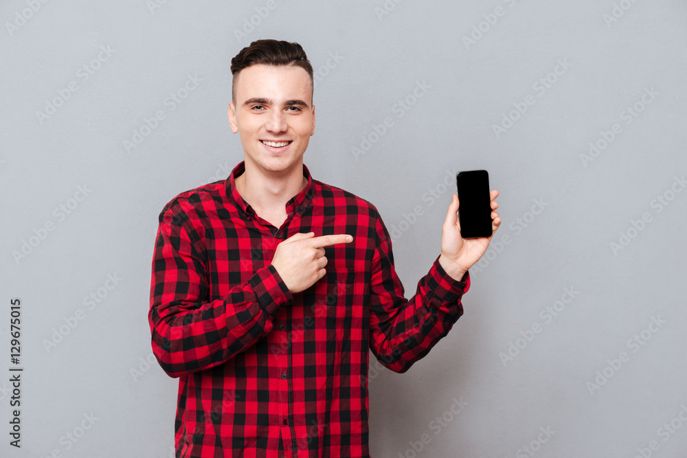 Man in shirt showing blank smartphone screen Man in shirt showing blank smartphone screen
