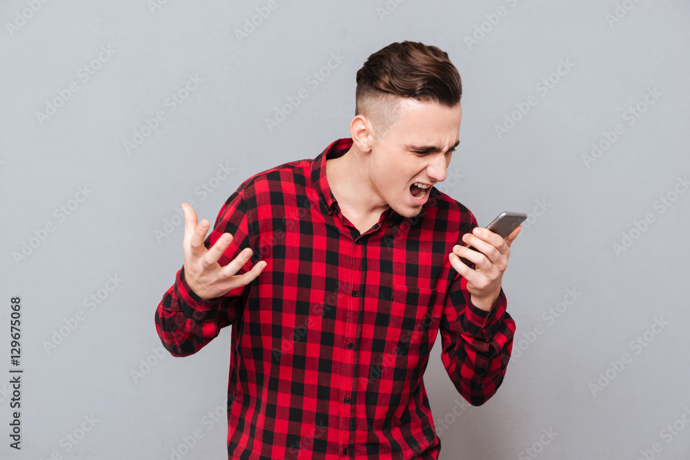 Man in shirt screaming in phone Man in shirt screaming in phone