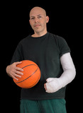 Young man in an arm cast after a basketball accident