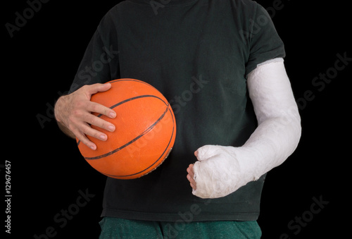 Young man in an arm cast after a basketball accident © Dotan