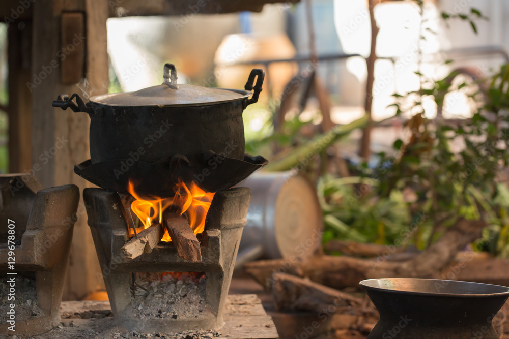 Old pot standing on wood burning stove Old pot standing on wood burning stove