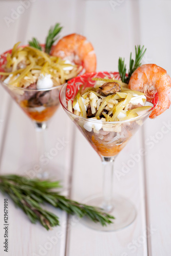 layered salad with seafood in a glass