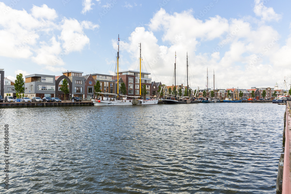 Obraz premium Noorderhaven canal with boats and houses in historic old town of Harlingen, Friesland, Netherlands