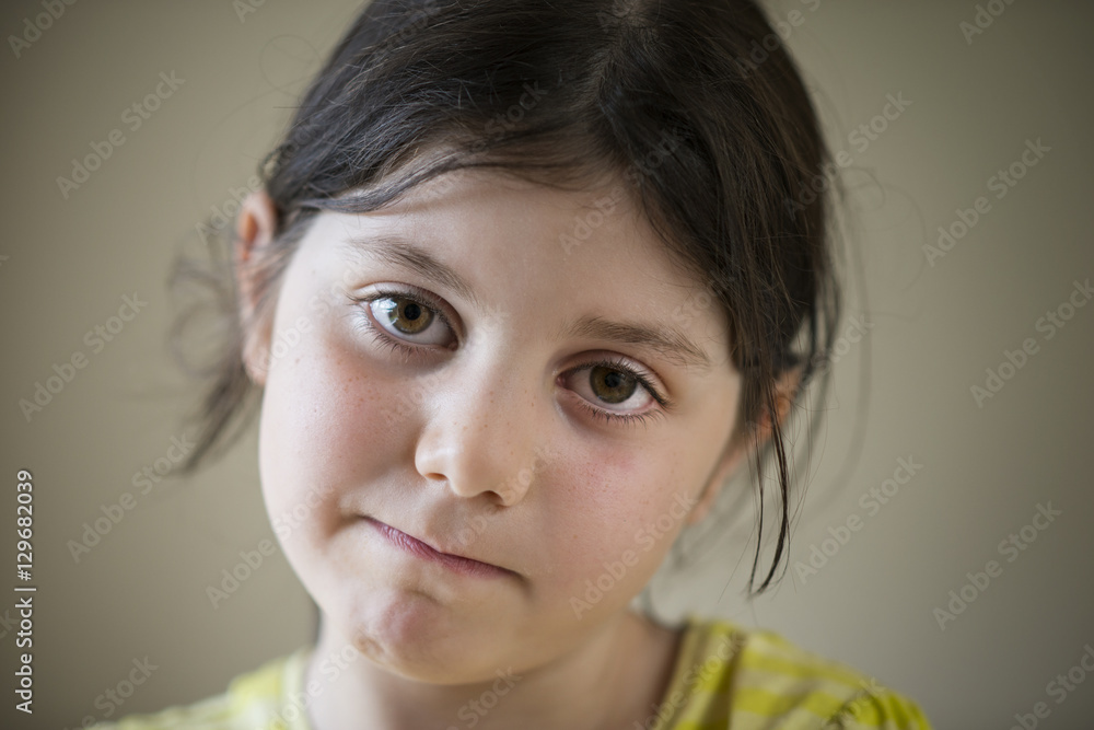 Sad young girl looking straight ahead Sad young girl looking straight ahead