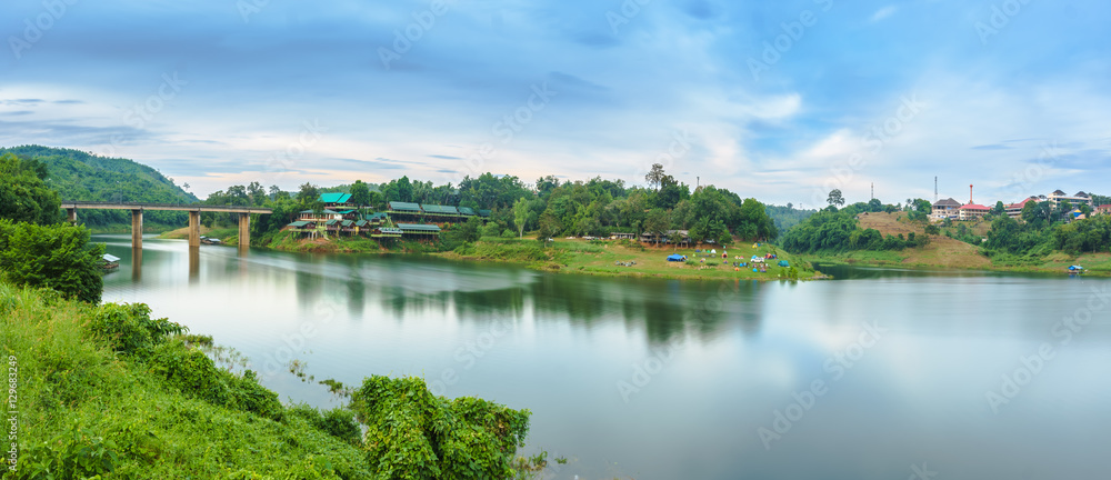 Kanchanaburi, Thailand - December 2016 - Panorama scene of Songkhalia Resort, Sangkhla Buri in evening with some of the traveler's tent. on December 3, 2016, in Sangkhlaburi District, Kanchanaburi Pro Kanchanaburi, Thailand - December 2016 - Panorama scene of Songkhalia Resort, Sangkhla Buri in evening with some of the traveler's tent. on December 3, 2016, in Sangkhlaburi District, Kanchanaburi Pro
