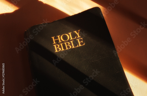 Holy Bible in light and shadow.