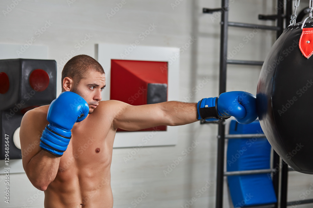 boxer man during boxing hitting heavy bag at training fitness gym boxer man during boxing hitting heavy bag at training fitness gym