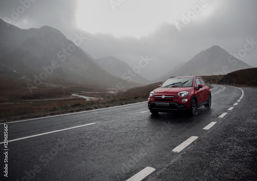 Car moving on road with mountains in background