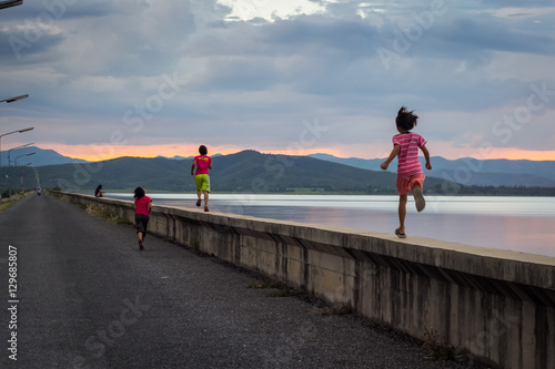 Children running at the dam
