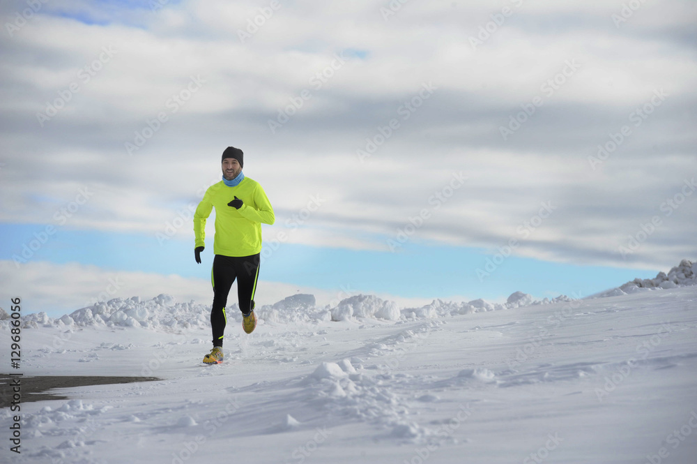 young healthy sport man running in snow mountains in trail runner hard workout in winter young healthy sport man running in snow mountains in trail runner hard workout in winter
