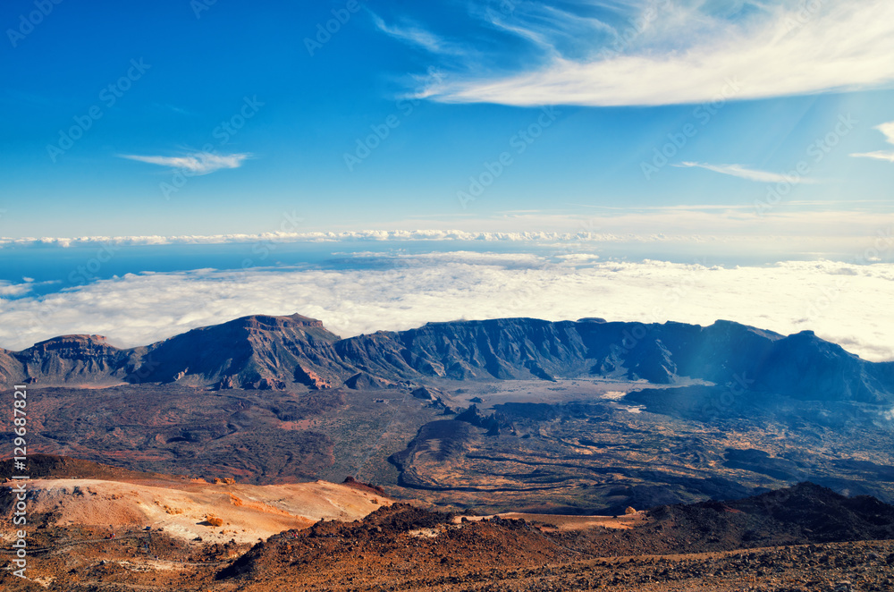 Beautiful aerial view of volcano caldera from summit Pico del Teide mountain. Lava rocks and volcanic Mars landscape in El Teide National park. Main landmark on Tenerife, Canary Islands, Spain.
