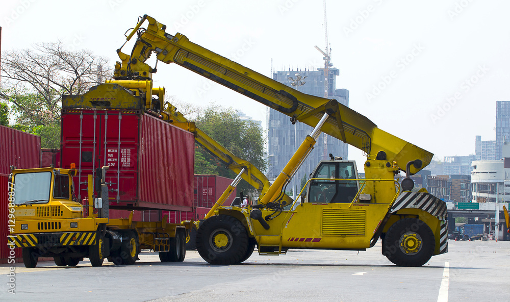 Fototapeta premium forklift handling container box loading to freight train